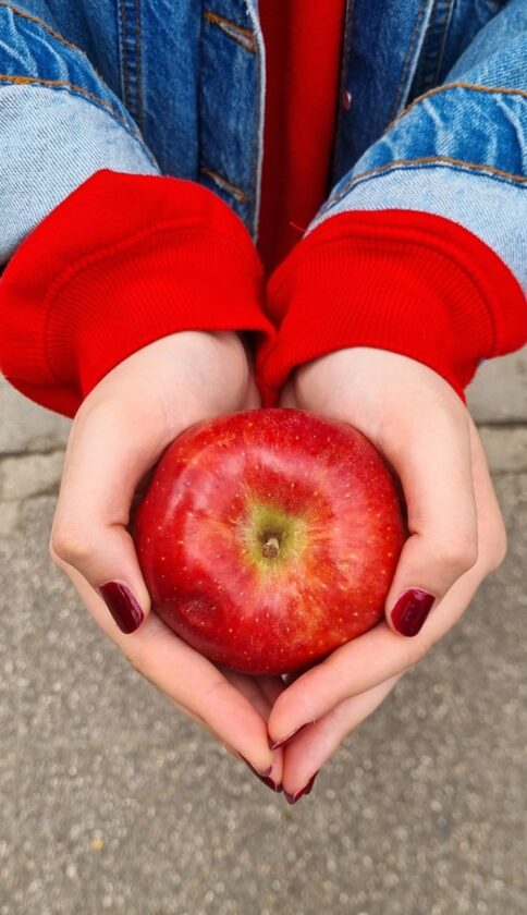 woman holding an apple in her hands